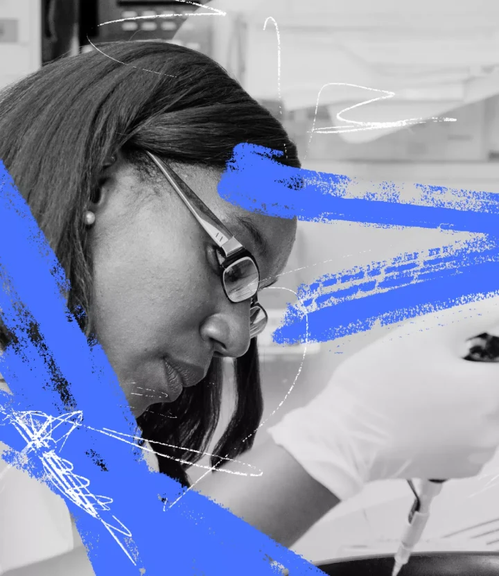 female scientist wearing gloves and using a dropper to run tests.